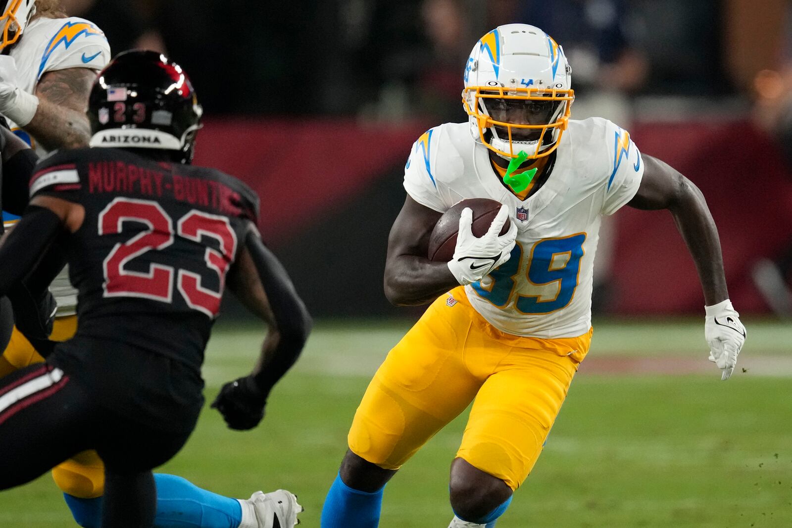 Los Angeles Chargers wide receiver Jalen Reagor (89) runs from Arizona Cardinals cornerback Sean Murphy-Bunting (23) after catching a pass during the first half of an NFL football game, Monday, Oct. 21, 2024, in Glendale Ariz. (AP Photo/Matt York)