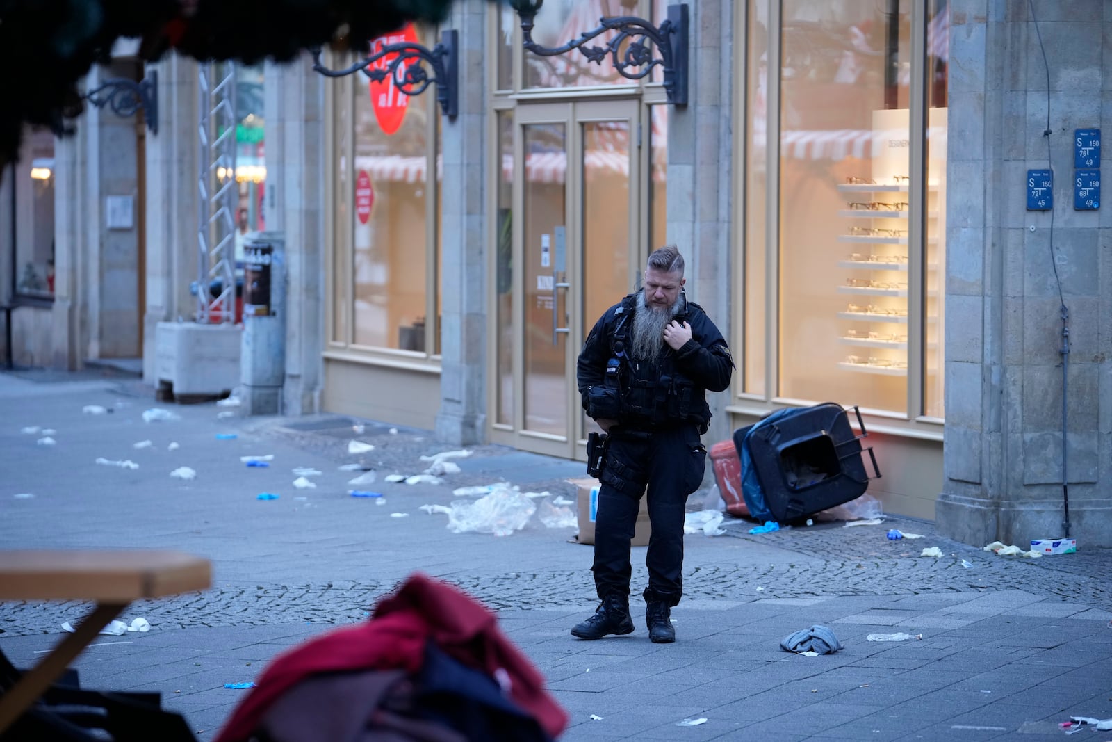 A police officer stands guard at at a cordoned-off area near a Christmas Market, where a car drove into a crowd on Friday evening, in Magdeburg, Germany, Saturday, Dec. 21, 2024. (AP Photo/Ebrahim Noroozi)