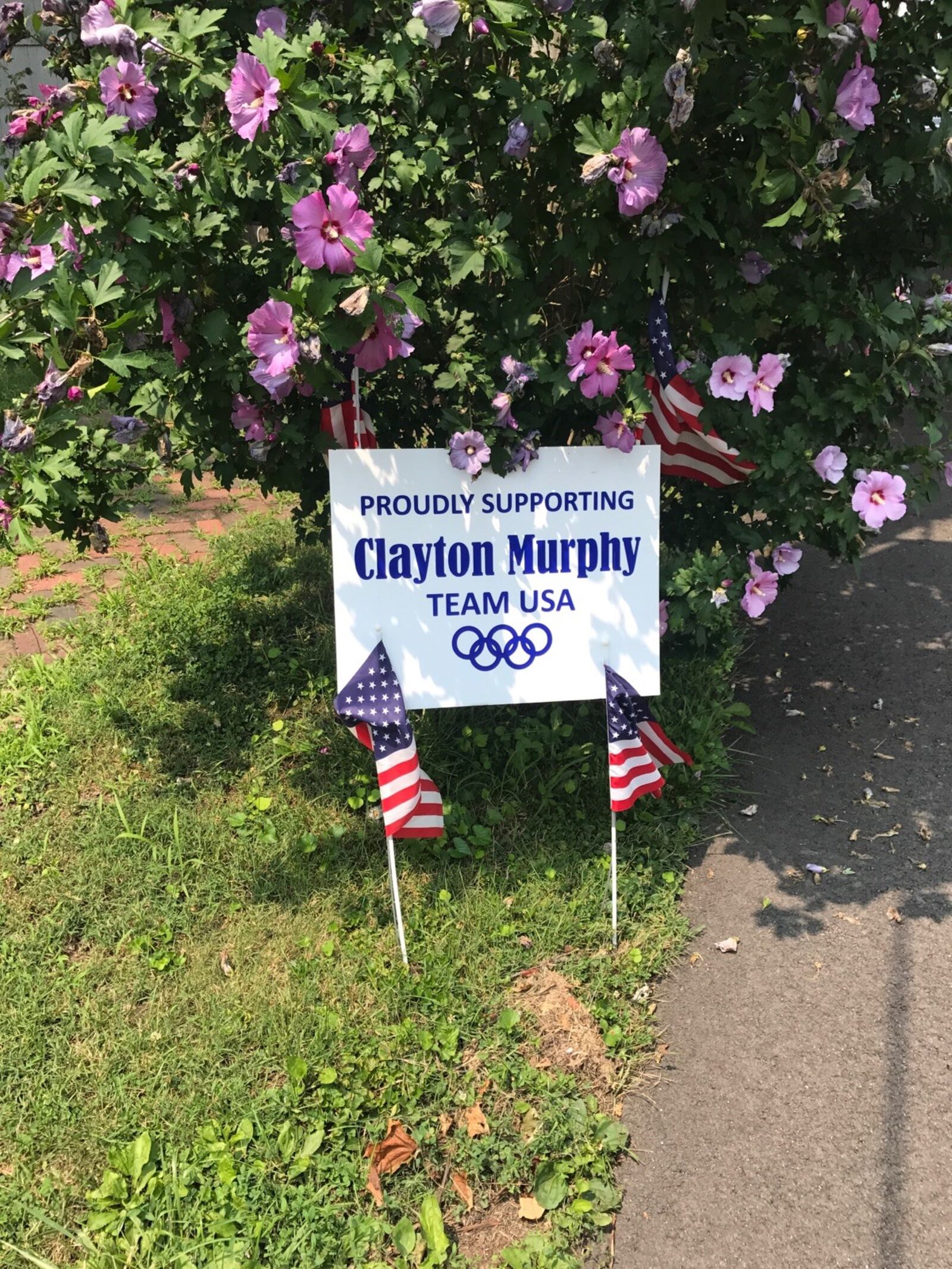 Residents in the village of New Madison are showing support for Olympian Clayton Murphy with signs all over town. Tom Archdeacon/STAFF