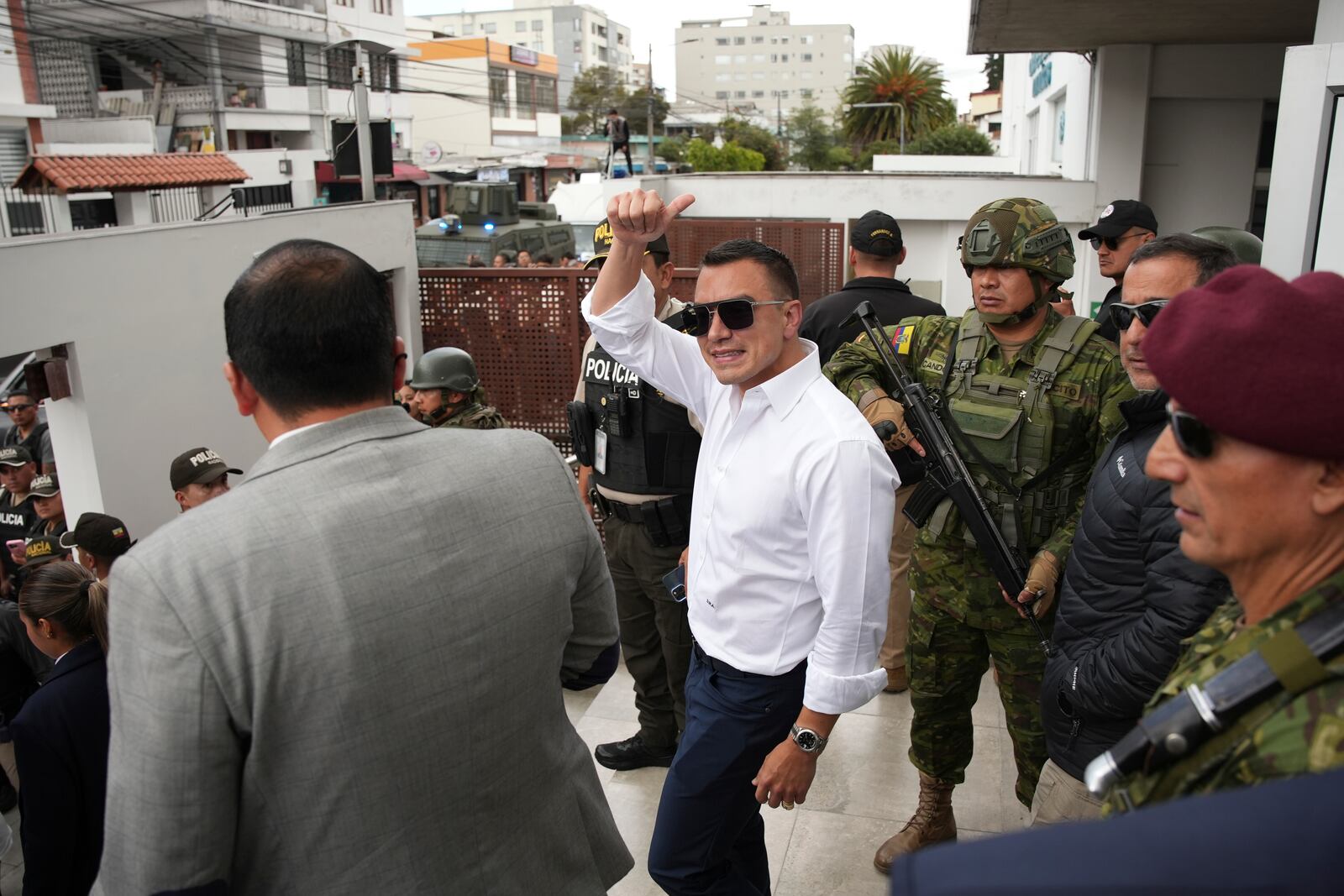 Ecuador's President Daniel Noboa, running for re-election, waves after accompanying his running mate, Maria Jose Pinto, to cast her ballot during the presidential elections in Quito, Ecuador, Sunday, Feb. 9, 2025. (AP Photo/Carlos Noriega)