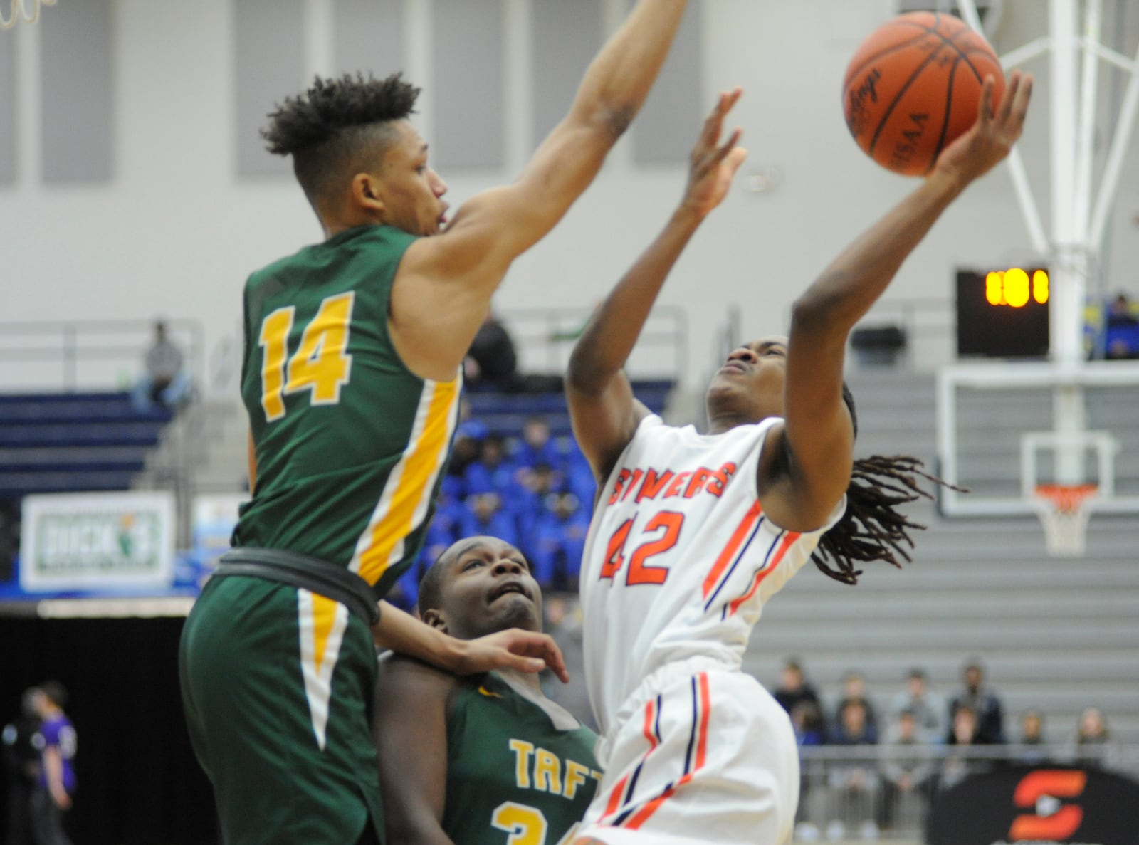 Antonio Aubrey of Stivers (right) gets off a contested shot. MARC PENDLETON / STAFF