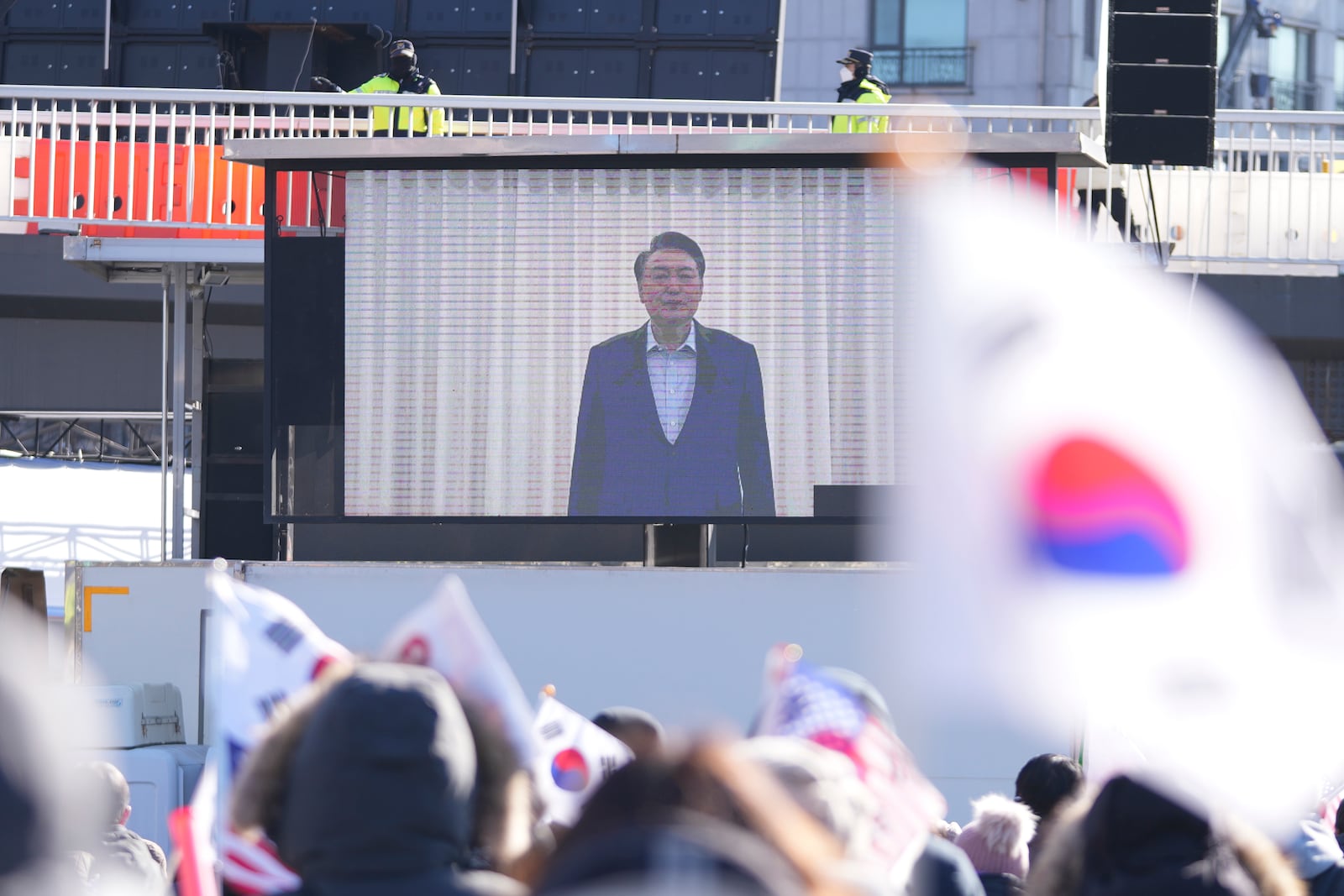 A huge screen shows a footage of impeached South Korean President Yoon Suk Yeol as supporters stage a rally to oppose his impeachment near the presidential residence in Seoul, South Korea, Wednesday, Jan. 15, 2025. (AP Photo/Lee Jin-man)