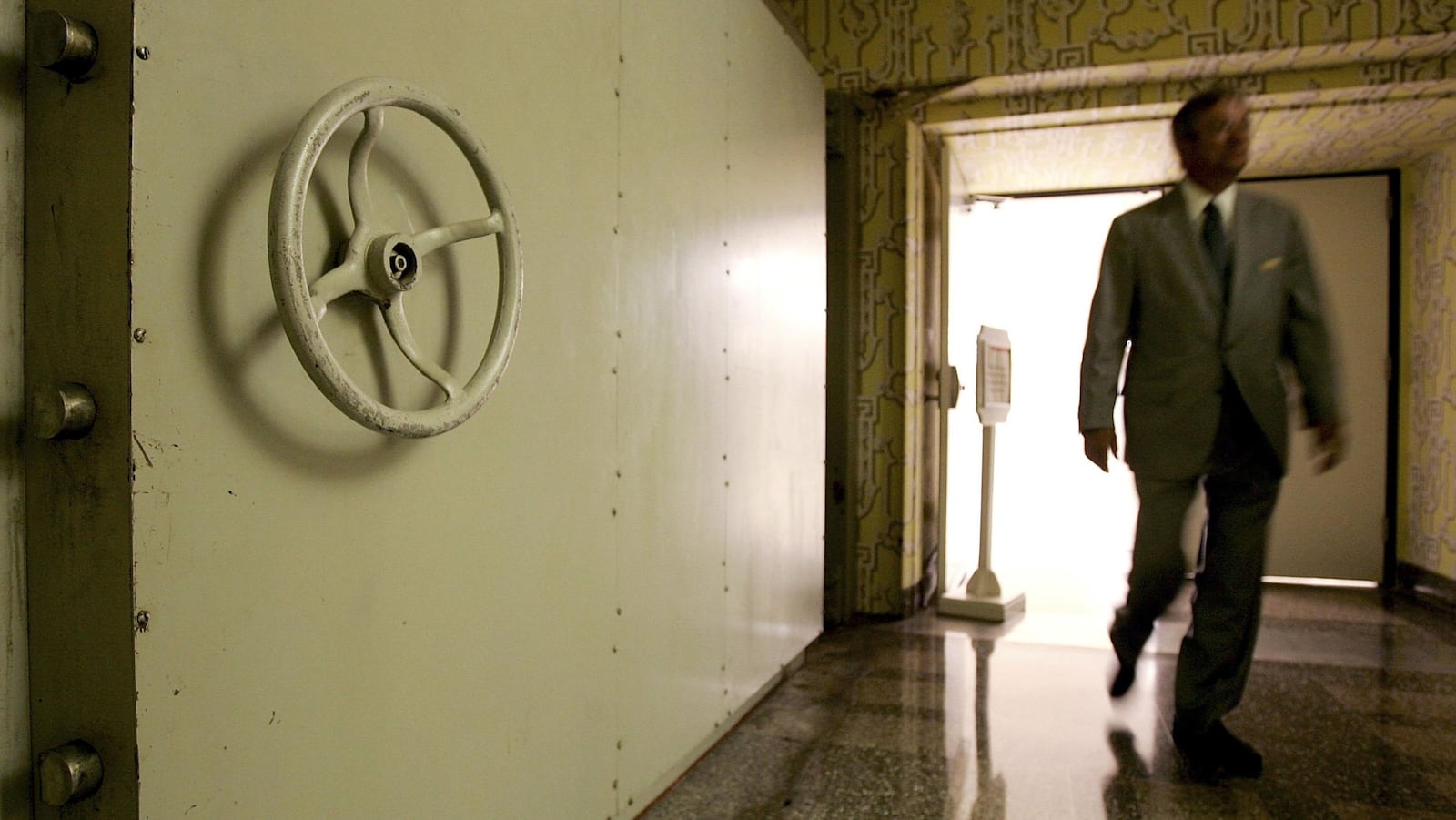 WHITE SULPHUR SPRINGS, WV - JULY 14:  A resort employee passes by the Hotel Blast Door, which weighs 18 tons and serves as an entrance to a former government relocation facility, also know as "the bunker," at Greenbrier Resort July 14, 2006 in White Sulphur Springs, West Virginia. The bunker, codenamed "Project Greek Island" and planned by the Eisenhower Administration, was a 112,000 square-foot shelter constructed beneath the Greenbrier Resort's West Virginia Wing, to serve as a relocation site for members of the U.S. Congress and associated staff in the event of a nuclear attack on the U.S. soil. The facility was built between 1958 and 1961 and was maintained in a state of operational readiness until the government terminated the lease with the resort in 1995. The bunker will be reopened for public tours on August 20 after a two-year-long renovation.  (Photo by Alex Wong/Getty Images)