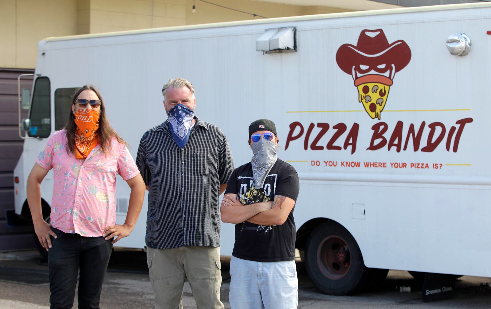 Brian Johnson, Mark Jeffers and James Burton (left to right) are the owners of the Pizza Bandit, a New York style pizza truck that can found at the Yellow Cab Tavern in Dayton.  LISA POWELL / STAFF