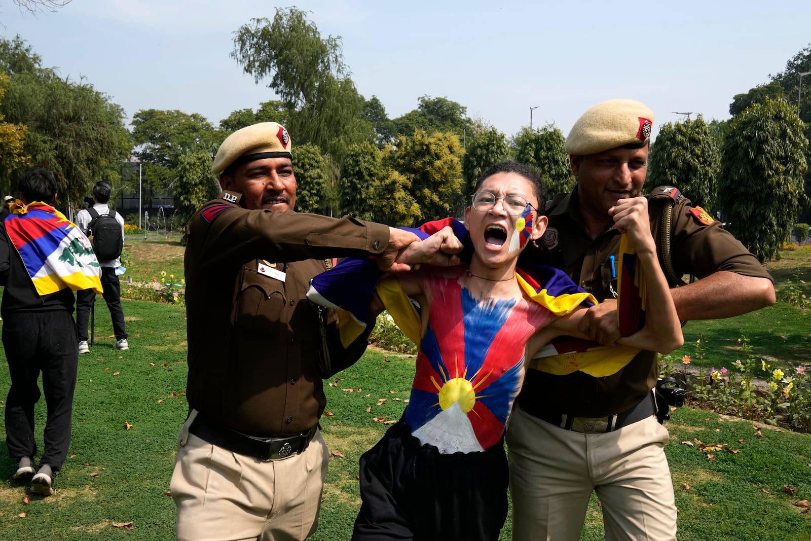 Police try to detain a protesting exile Tibetan during a protest outside Chinese embassy to mark the 1959 uprising in Tibet against the Chinese rule on this day, in New Delhi,India, Monday, March, 10, 2025. (AP Photo/Manish Swarup)