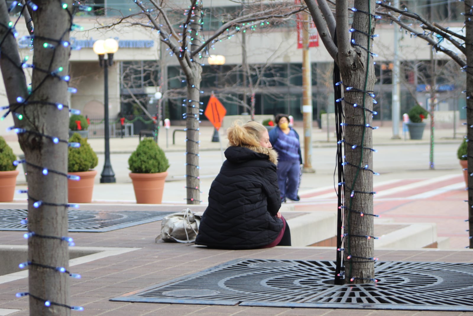 Multiple people hang out in Courthouse Square in downtown Dayton. CORNELIUS FROLIK / STAFF