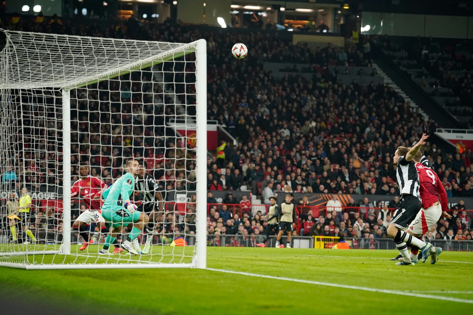 Manchester United's Amad Diallo, left, scores the opening goal during the Europa League opening phase soccer match between Manchester United and PAOK at the Old Trafford stadium in Manchester, England, Thursday, Nov. 7, 2024. (AP Photo/Dave Thompson)