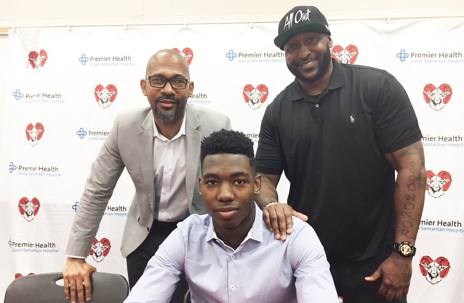 Trotwood-Madison High School senior Myles Belyeu is flanked by his father Scott Belyeu (left) and uncle Shareef Martin. Myles signed to play basketball at Saginaw Valley State University on Thursday, May 3, 2018. MARC PENDLETON / STAFF