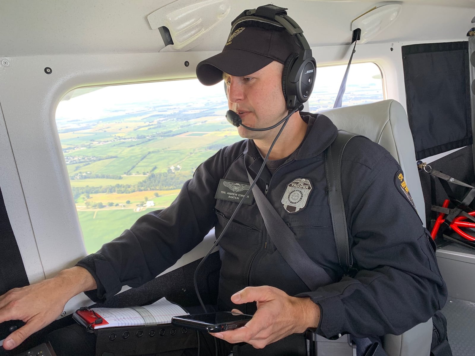 Ohio Highway Patrol Trooper Andrew Edinger operates a high-definition camera mounted to the belly of the patrol-owned Gipps Aero Airvan to capture moving violations that may indicate aggressive or distracted driving. STAFF