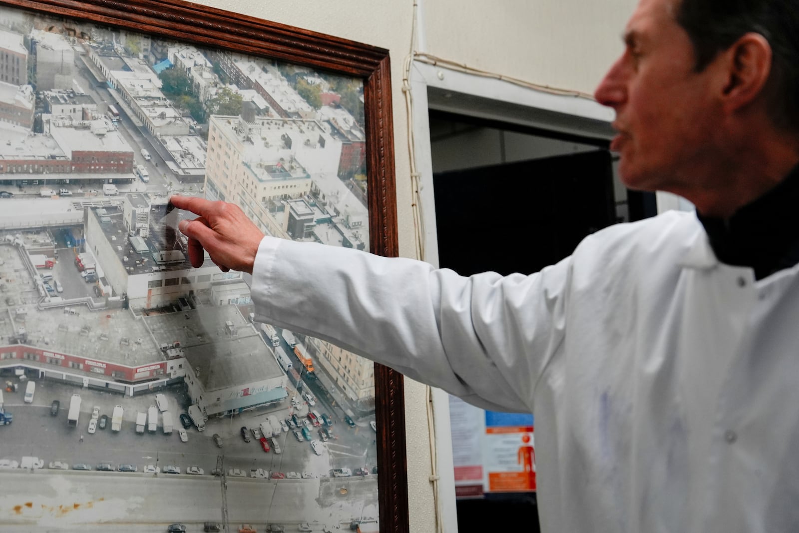 John Jobbagy explains a photo of the Meatpacking District of Manhattan during an interview with The Associated Press at J.T. Jobbagy Inc. in the Meatpacking District of Manhattan, Tuesday, Nov. 19, 2024, in New York. (AP Photo/Julia Demaree Nikhinson)