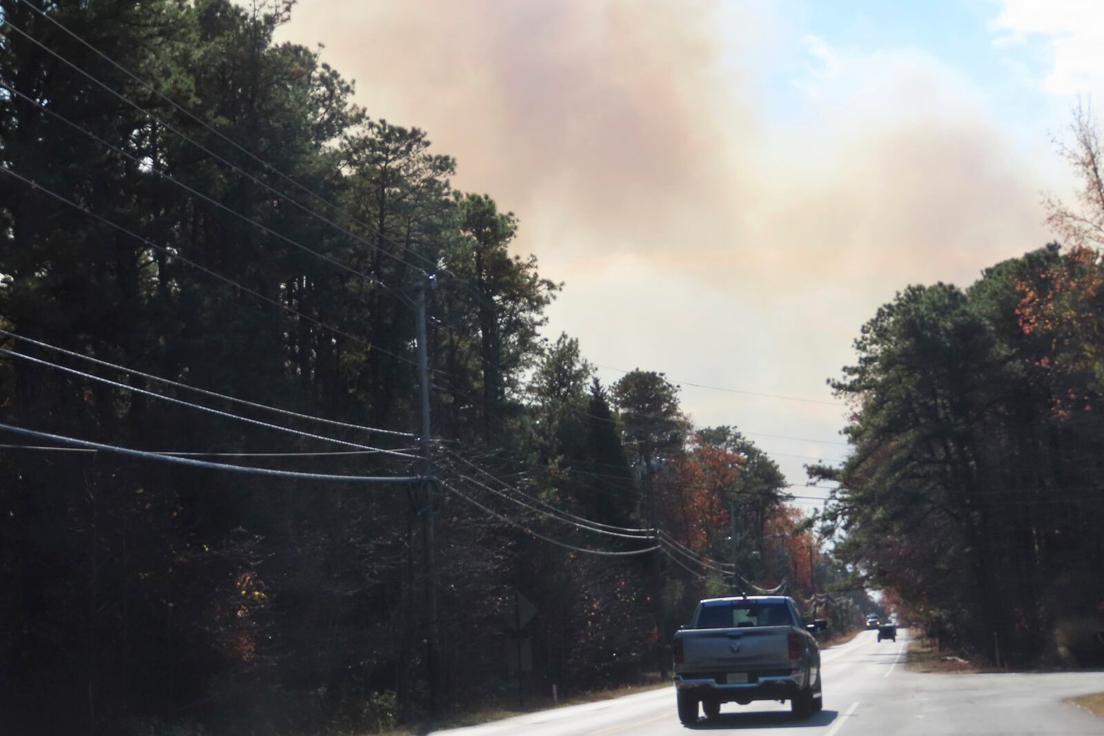 Smoke from a forest fire rises above the trees in Evesham,N.J. on Thursday, Nov. 7, 2024, when firefighters said conditions were the driest in New Jersey in nearly 120 years. (AP Photo/Wayne Parry)