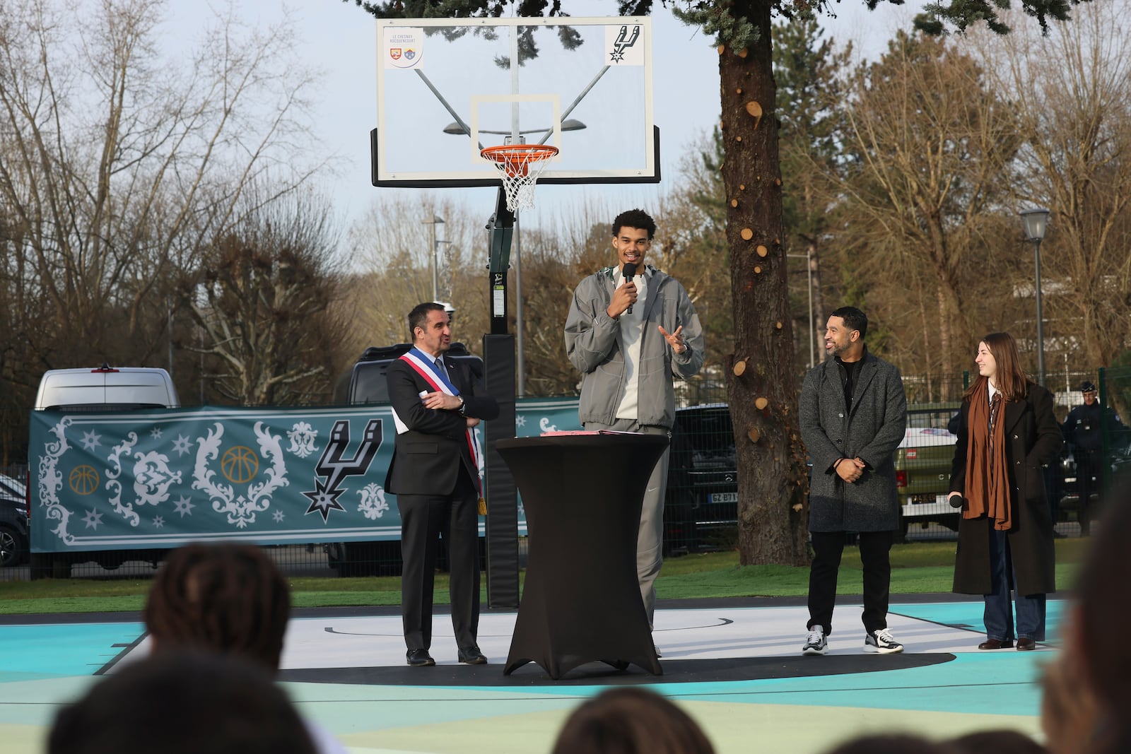 San Antonio Spurs' Victor Wembanyama delivers a speech as he inaugurates a basketball court, Tuesday, Jan. 21, 2025 in Le Chesnay-Rocquencourt, south of Paris. (AP Photo/Thomas Padilla)