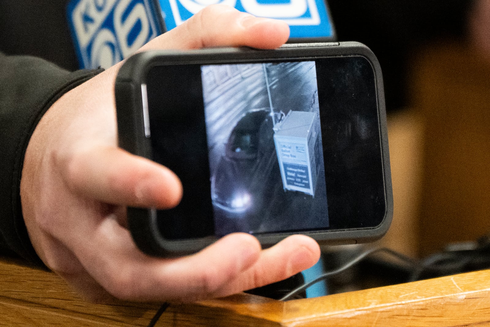 Portland Police Bureau spokesman Mike Benner displays an image from surveillance video during a news conference at the Multnomah County Elections Division office on Monday, Oct. 28, 2024, in Portland, Ore. (AP Photo/Jenny Kane)