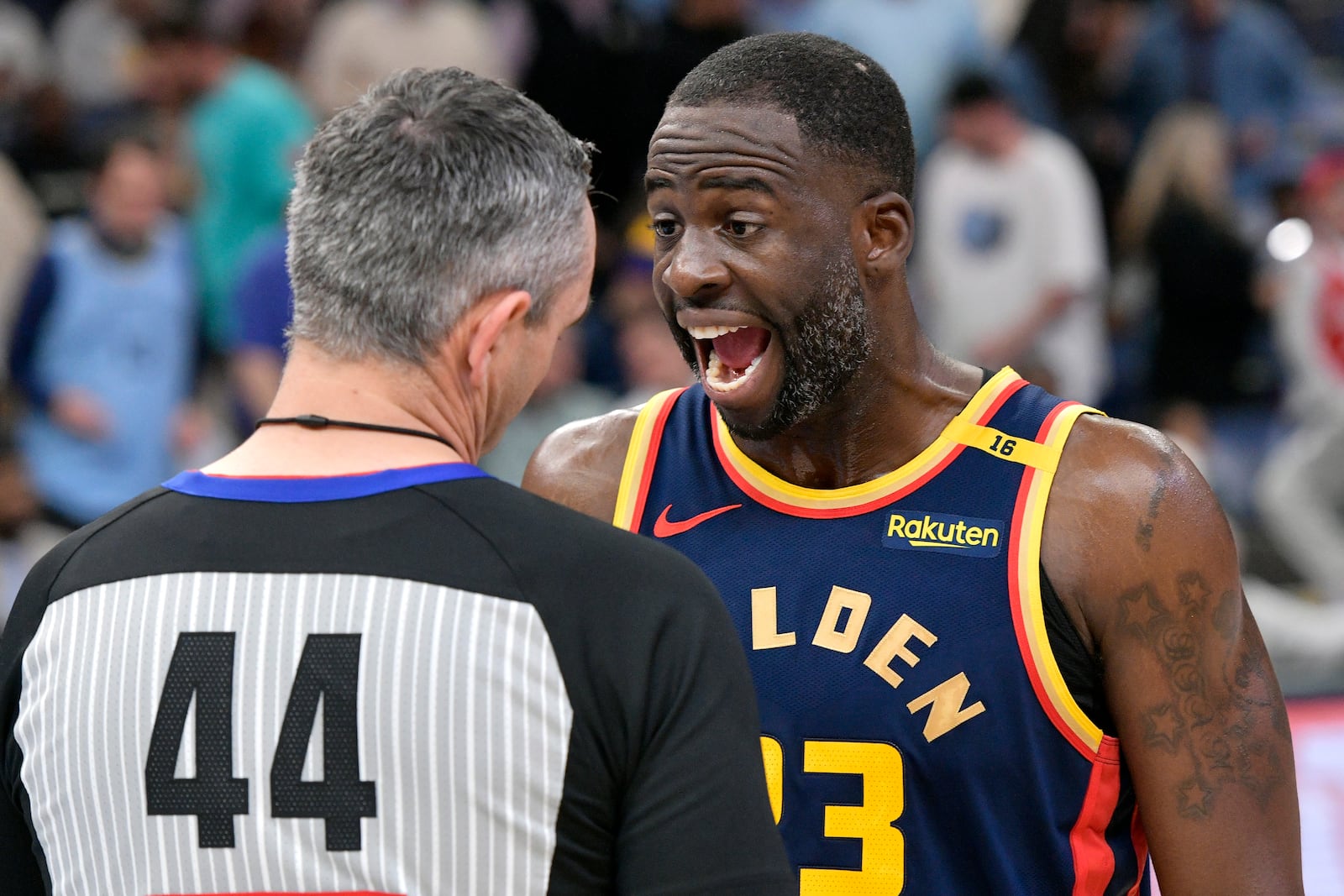 Golden State Warriors forward Draymond Green, right, talks to referee Brett Nansel (44) in the first half of an NBA basketball game against the Memphis Grizzlies, Thursday, Dec. 19, 2024, in Memphis, Tenn. (AP Photo/Brandon Dill)