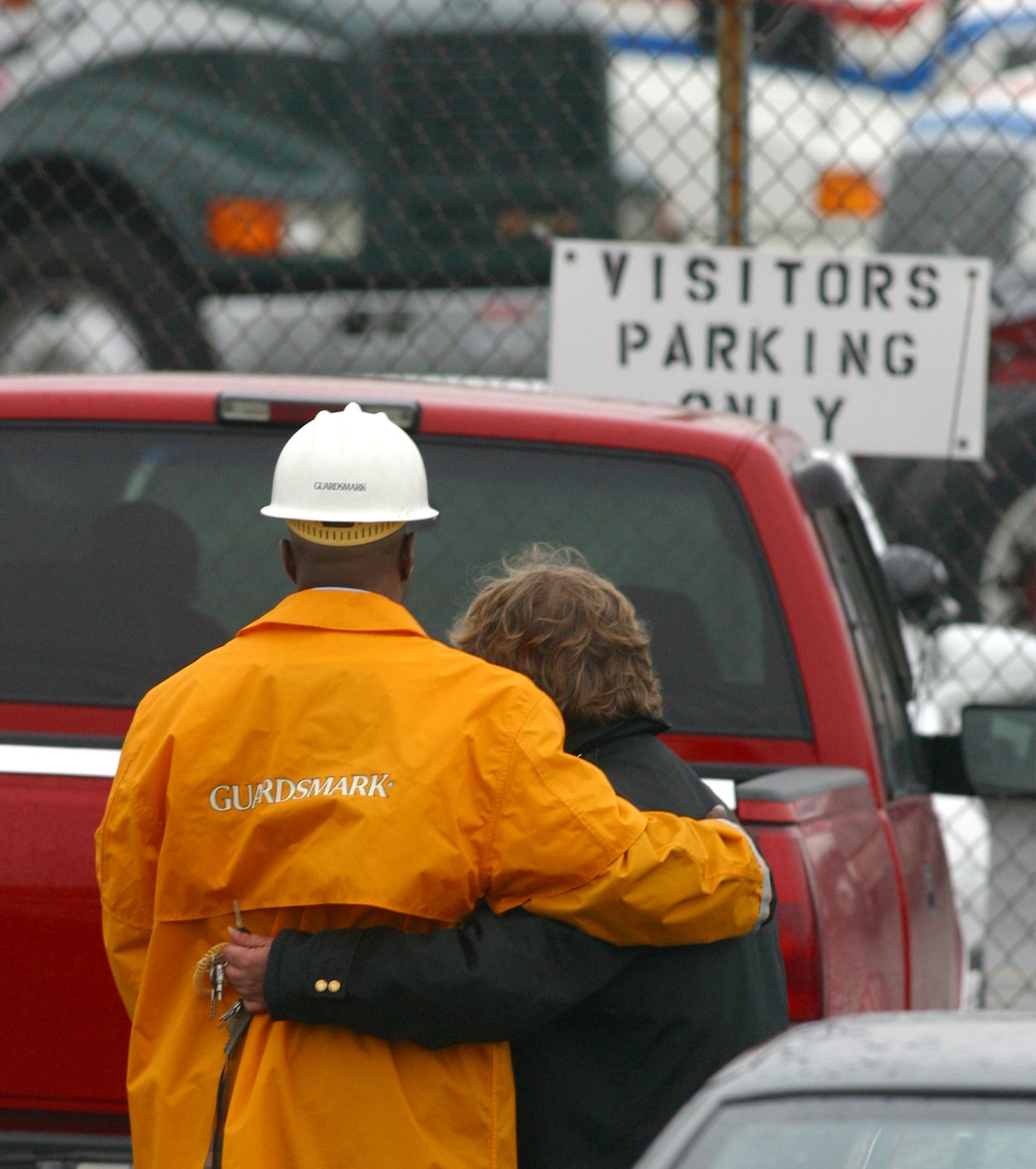 11-6-03  --   Security guards for Watkins Motor Lines in West Chester hug outside the trucking docks after two people were killed and three others injured inn a shooting rampage on Nov. 6, 2003. TY GREENLEES / STAFF