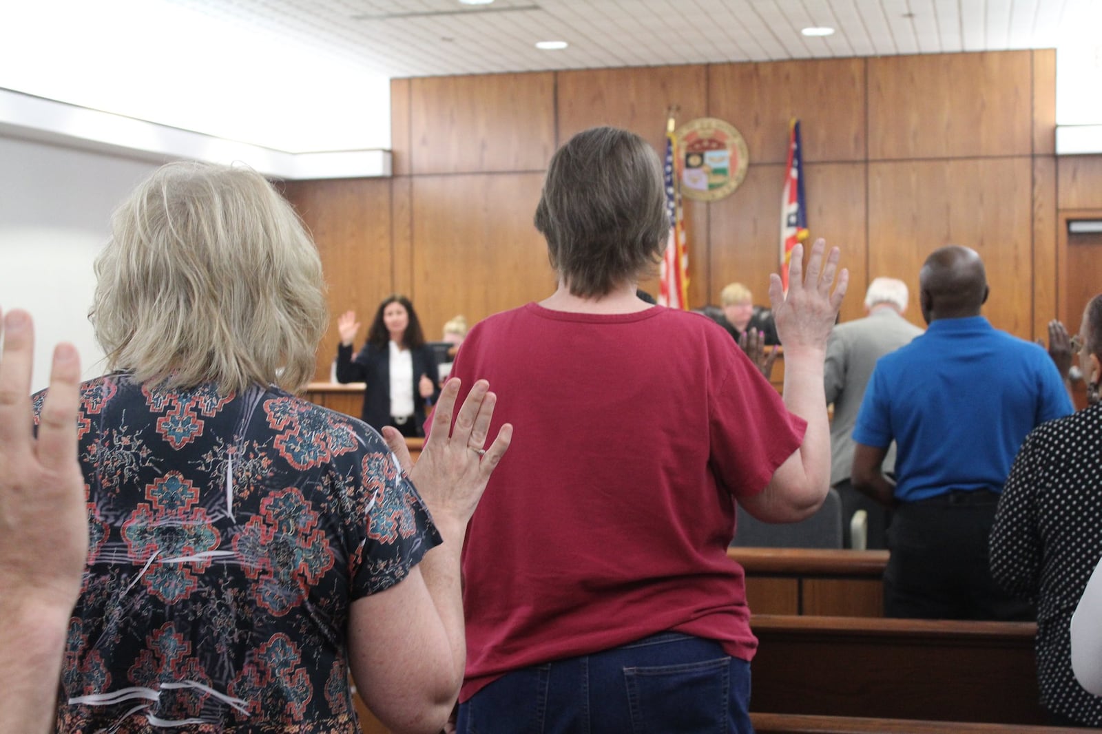 Visitors to Dayton Municipal Court in 2018 raise their right hands to swear they will tell the truth in testimony about eviction cases. CORNELIUS FROLIK / STAFF