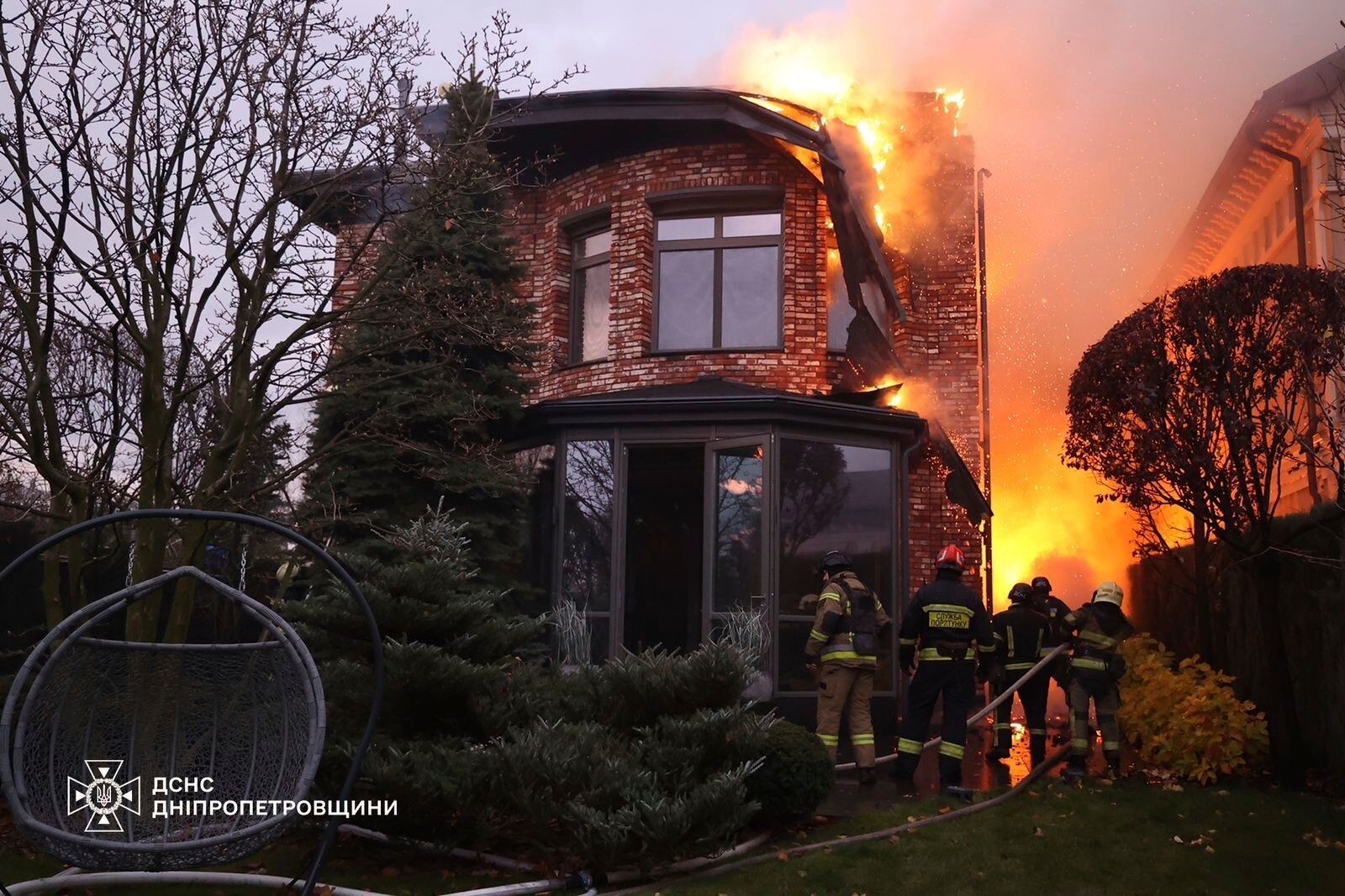 In this photo provided by the Ukrainian Emergency Services on Nov. 21, 2024, rescue workers put out a fire of a burning house damaged by a Russian strike on Dnipro, Ukraine. (Ukrainian Emergency Service via AP)