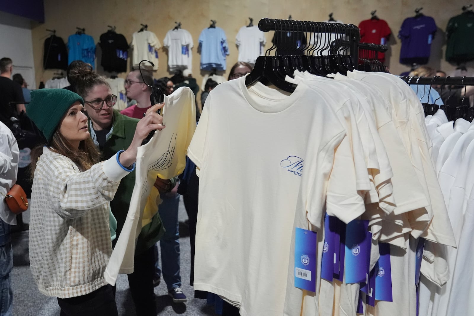 Fans shop for merchandise before the Unrivaled 3-on-3 women's basketball game between Lunar Owls and Mist, Friday, Jan. 17, 2025, in Medley, Fla. (AP Photo/Marta Lavandier)