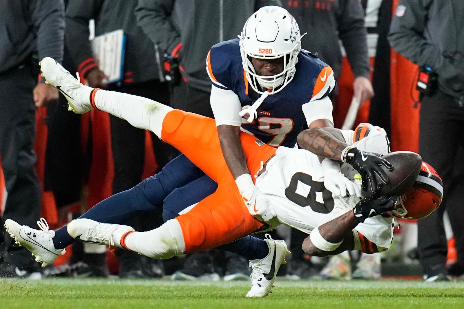 Cleveland Browns wide receiver Elijah Moore (8) is defended by Denver Broncos cornerback Ja'Quan McMillian (29) during the second half of an NFL football game, Monday, Dec. 2, 2024, in Denver. (AP Photo/Jack Dempsey)