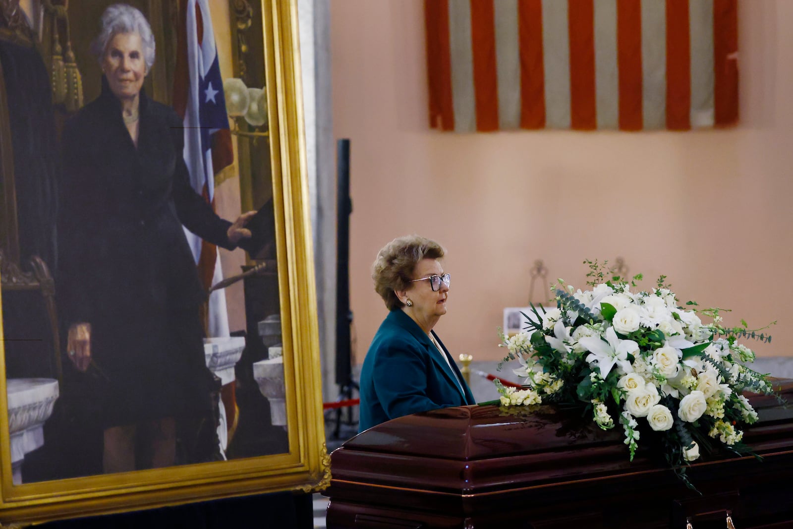 Former Ohio Attorney General Betty Montgomery pauses at the casket for former Ohio House speaker Jo Ann Davidson as it lie in state in the rotunda of the Ohio Sate House in Columbus, Ohio, Thursday, Oct. 31, 2024. (AP Photo/Paul Vernon)