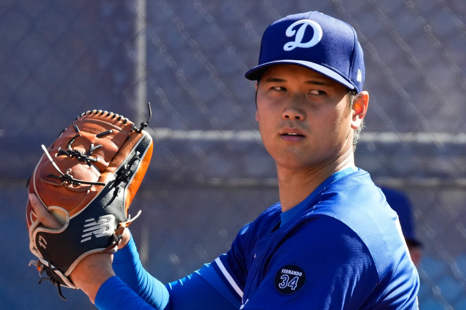 Los Angeles Dodgers two-way player Shohei Ohtani (17) works out during spring training baseball practice, Saturday, Feb. 15, 2025, in Phoenix. (AP Photo/Ashley Landis)