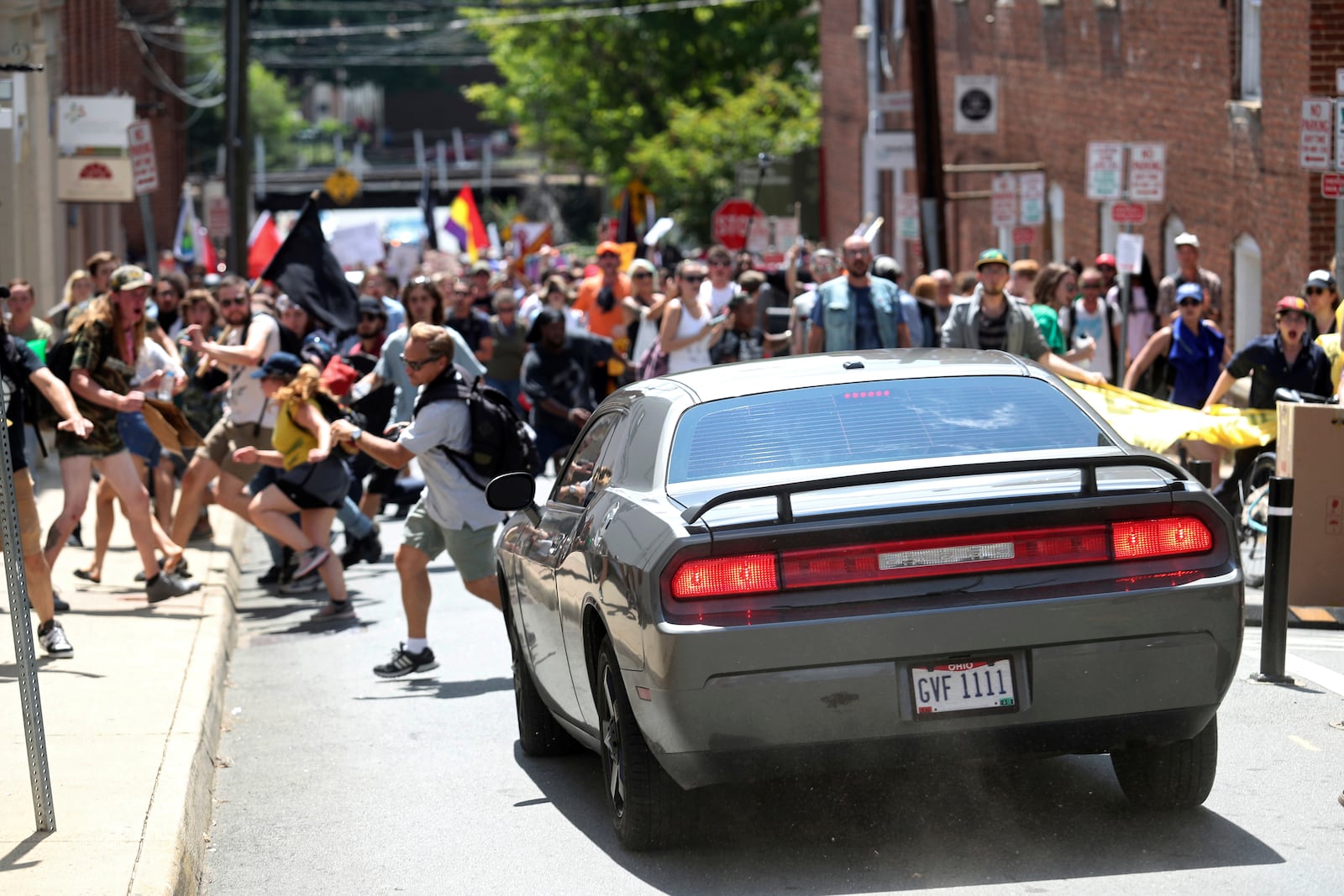 FILE - In this Aug. 12, 2017 file photo, a vehicle drives into a group of protesters demonstrating against a white nationalist rally in Charlottesville, Va.  A federal judge on Wednesday, May 5, 2021,  has ordered a right-wing think tank led by white nationalist Richard Spencer to pay $2.4 million to an Ohio man severely injured during a white supremacist and neo-Nazi rally two years ago in Virginia organized by Spencer.  Bill Burke says he was struck by a car driven by James Alex Fields Jr. , in a crash that killed counterprotester Heather Heyer, during the August 2017 rally in Charlottesville. (Ryan M. Kelly/The Daily Progress via AP)