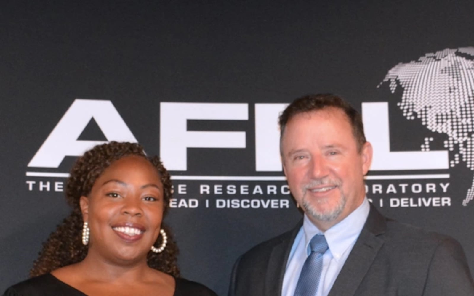 AFRL Small Business Senior Program Manager Anissa Lumpkin (left) and AFRL Small Business Director Brian McJilton in front of the Air Force Research Laboratory booth prior to the start of Day 2 of the Air Force Historically Black Colleges & Universities and Minority Serving Institutions Outreach Initiative Collider held in Dayton, Ohio at the Wright Brothers Institute, 444 Building, in August 2021. Air Force photo.