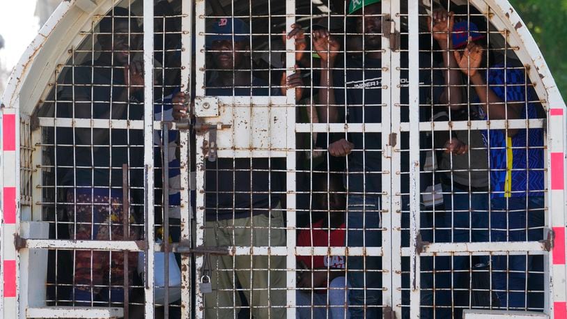 FILE - Undocumented Haitians detained by immigration officials stand inside a police vehicle, in Dajabon, Dominican Republic, May 17, 2024. (AP Photo/Matias Delacroix, File)