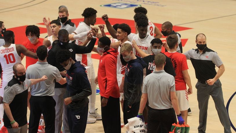 Dayton's Mustapha Amzil, Moulaye Sissoko, Jordy Tshimanga and Brett Comer huddle before a game against La Salle on Wednesday, Dec. 30, 2020, at UD Arena. David Jablonski/Staff