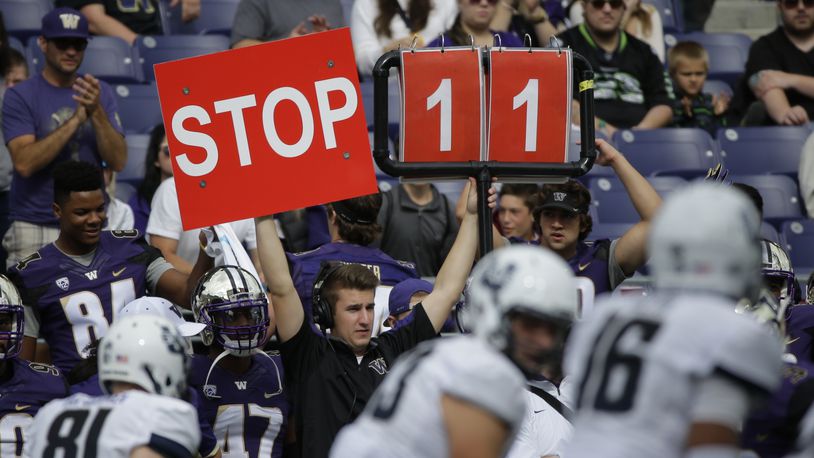 FILE - A play is signaled from the Washington sideline in the second half of an NCAA college football game against Utah State in Seattle, Sept. 19, 2015. (AP Photo/Ted S. Warren, File)