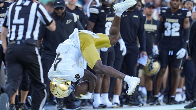 Notre Dame running back Jeremiyah Love (4) flips after being tackled during the second half of an NCAA college football game against Purdue in West Lafayette, Ind., Saturday, Sept. 14, 2024. (AP Photo/Michael Conroy)