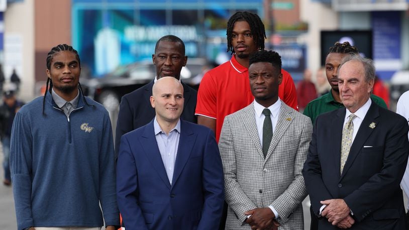 Dayton's Anthony Grant and DaRon Holmes II, back row, pose for a photo with other coaches and players at Atlantic 10 Conference Media Day on Tuesday, Oct. 17, 2023, at the Barclays Center in Brooklyn, N.Y. David Jablonski/Staff