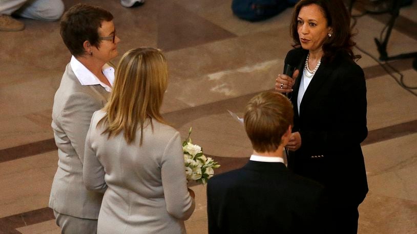 FILE - Attorney General Kamala Harris, right, officiates the wedding of Kris Perry, from left, and Sandy Stier, in San Francisco, June 28, 2013. (AP Photo/Jeff Chiu, File)