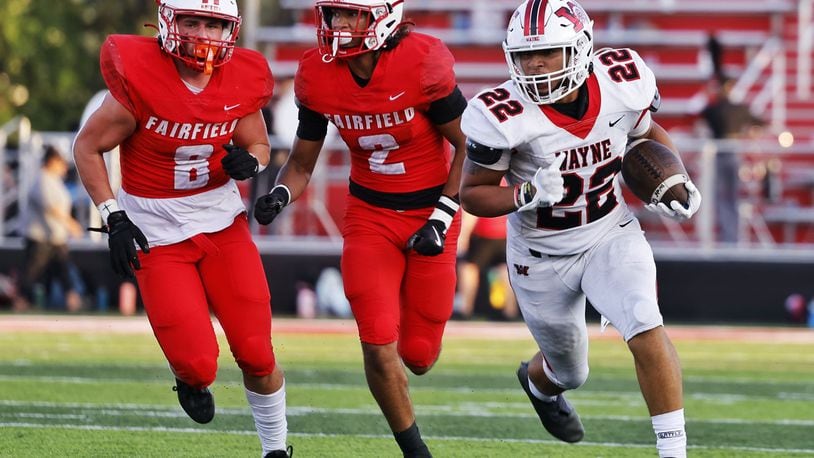 Wayne's Isaiah Thompson runs for yardage as Fairfield's Mason Gatto (8) and Kobe Lewis pursue during Friday night's season-opener at Fairfield. Nick Graham/STAFF