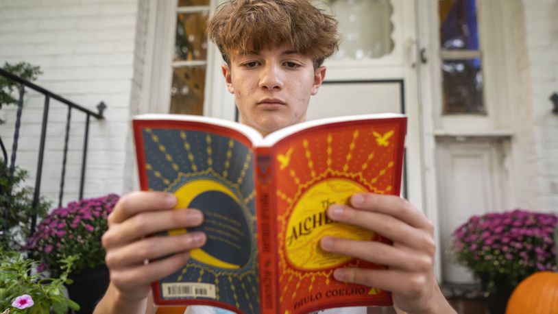 Chris Stanislawski, 14, poses for a portrait outside of his home in Garden City, N.Y., on Friday, Sept. 13, 2024. Chris didn't finish any books in his 8th grade English class, in part because their google classroom had detailed summaries of each chapter of every book. (AP Photo/Brittainy Newman)