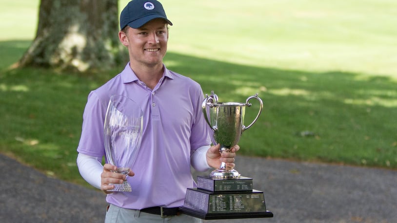 Tyler Goecke holds his award and the traveling cup that bears the name of each winner after winning the 102nd Metro at Miami Valley Golf Club on Sunday. Jeff Gilbert/CONTRIBUTED