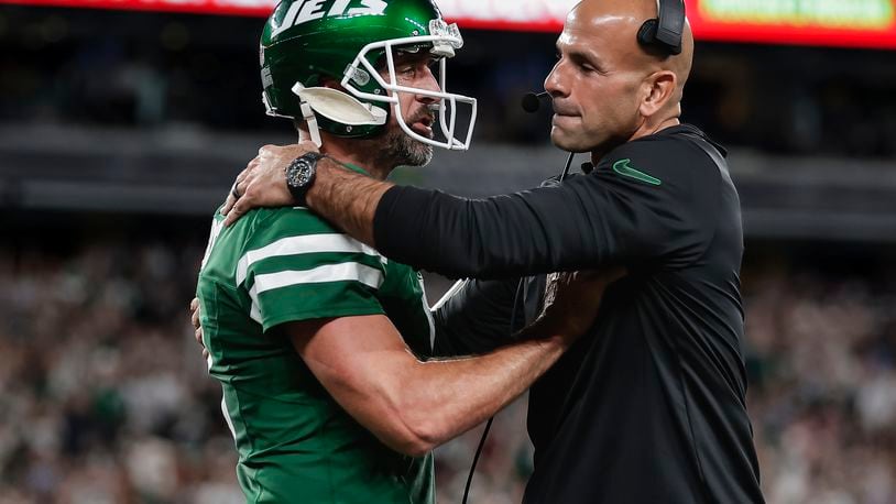 New York Jets quarterback Aaron Rodgers (8) talks with New York Jets head coach Robert Saleh during the first quarter of an NFL football game against the New England Patriots, Thursday, Sept. 19, 2024, in East Rutherford, N.J. (AP Photo/Adam Hunger)