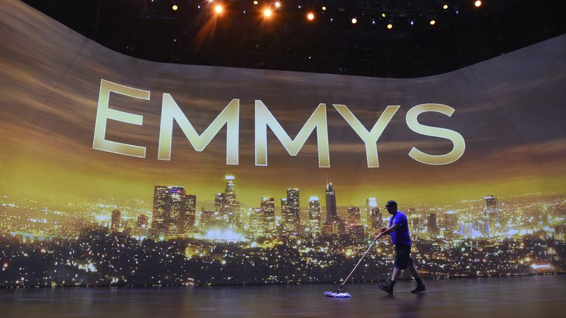 FILE - A crew member sweeps the stage during Press Preview Day for the 71st Primetime Emmy Awards in Los Angeles on Sept. 19, 2019. (Photo by Chris Pizzello/Invision/AP, File)