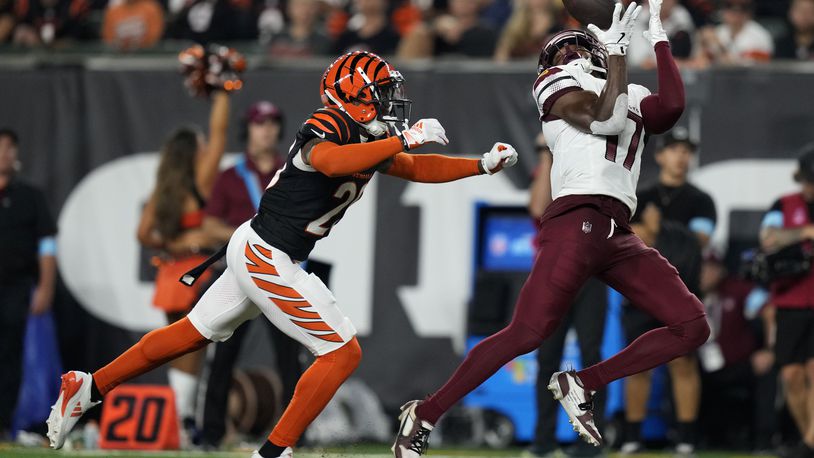 Washington Commanders wide receiver Terry McLaurin (17) catches a pass in front of Cincinnati Bengals cornerback Cam Taylor-Britt (29) during the first half of an NFL football game, Monday, Sept. 23, 2024, in Cincinnati. (AP Photo/Carolyn Kaster)