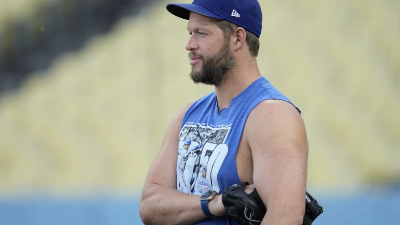 Los Angeles Dodgers pitcher Clayton Kershaw stands on the field during practice in preparation for Game 1 of a baseball NL Division Series against the San Diego Padres in Los Angeles, Friday, Oct. 4, 2024. (AP Photo/Ashley Landis)