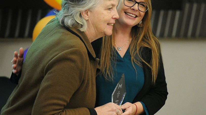 Leigh Ann Fulford (left) presents Brittini Long (right) with the Montgomery County Prevention Coalition's Visionary of the Year award. MARSHALL GORBY\STAFF