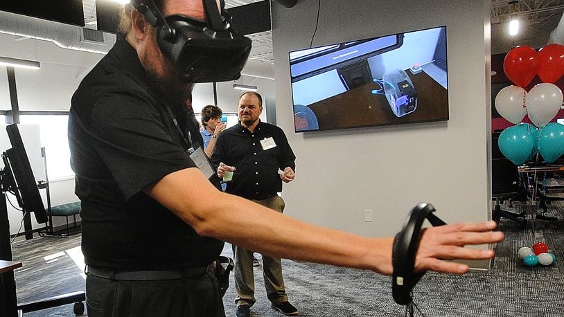 Josh Latham, demonstrates virtual reality training at the new University of Dayton Research Institute, Digital Transformation Center (DTC) Wednesday, Nov. 8, 2023. MARSHALL GORBY\STAFF