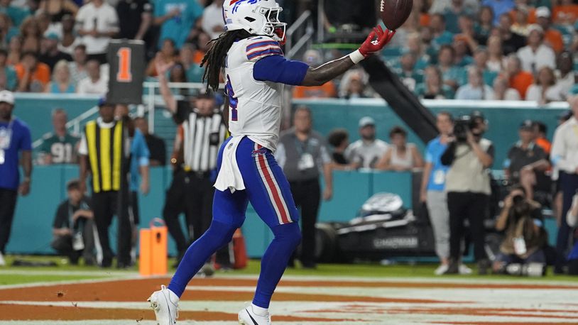 Buffalo Bills running back James Cook (4) scores a touchdown during the first half of an NFL football game against the Miami Dolphins, Thursday, Sept. 12, 2024, in Miami Gardens, Fla. (AP Photo/Lynne Sladky)