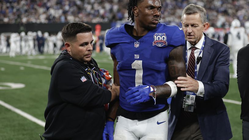 New York Giants wide receiver Malik Nabers (1) is helped off the field after an injury during the fourth quarter of an NFL football game against the Dallas Cowboys, Thursday, Sept. 26, 2024, in East Rutherford, N.J. (AP Photo/Adam Hunger)