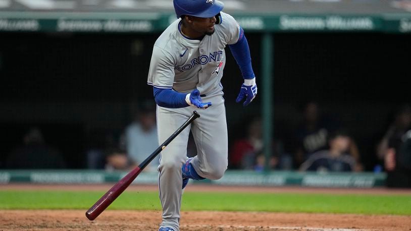 Toronto Blue Jays' Orelvis Martinez drops his bat and runs to first base with his first hit in the majors, during the sixth inning of the team's baseball game against the Cleveland Guardians, Friday, June 21, 2024, in Cleveland. (AP Photo/Sue Ogrocki)