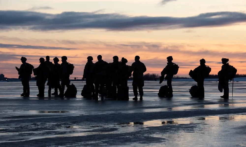 U.S. Air Force tactical air control party (TACP) specialists from Detachment 1, 3rd Air Support Operations Squadron, and combat weather Airmen assigned to Detachment 3, 1st Combat Weather Squadron, wait to board an Alaska Air National Guard C-17 Globemaster III while conducting airborne operations at Joint Base Elmendorf-Richardson, Alaska, Feb. 22, 2022. Members of the Alaska Air National Guards 176th Wing provided air support for the training. The Air Force special warfare Airmen conducted the training to demonstrate airborne and mission-readiness skills in Arctic conditions. (U.S. Air Force photo by Alejandro Pea)