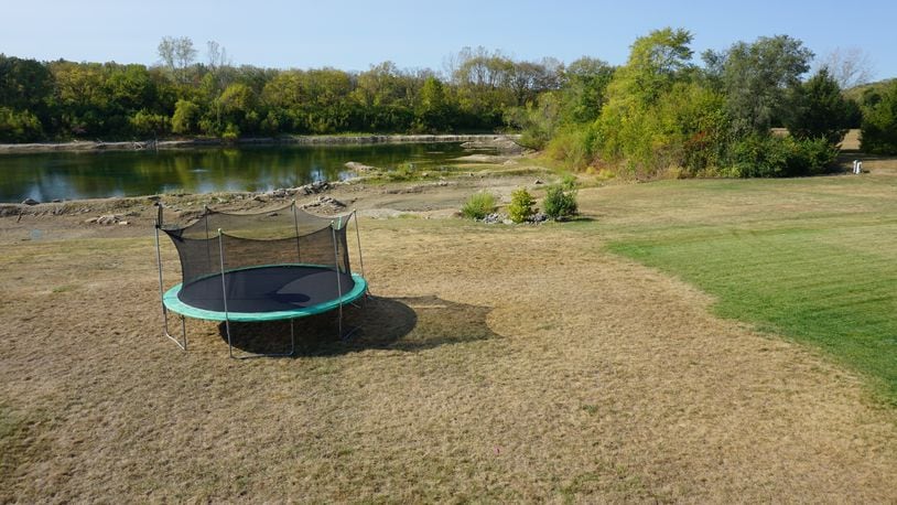 Lawn on the right is still being watered regularly and the lawn on the left is dormant. Note the pond in the background is well below the original shoreline.