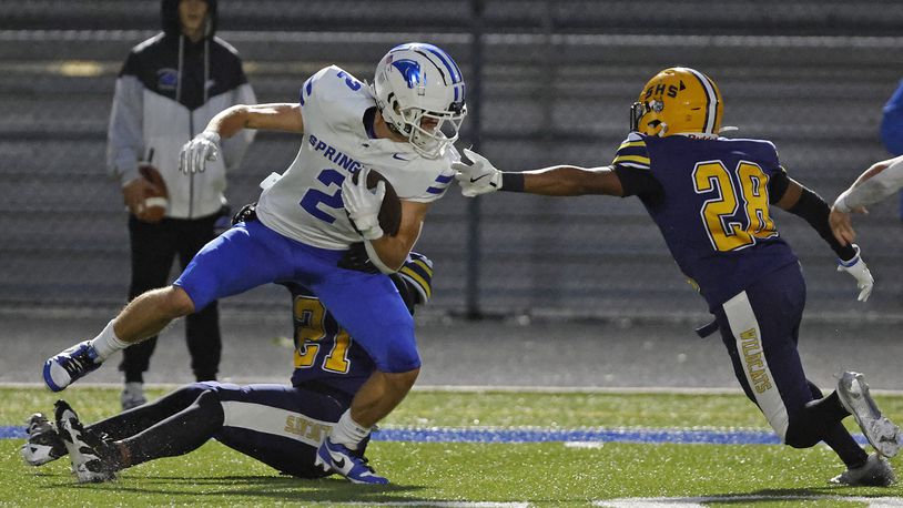 Springboro's Drew Balogh is tackled by Springfield's Rashad Walker Cherry and Ty'Juan Wright. BILL LACKEY/STAFF