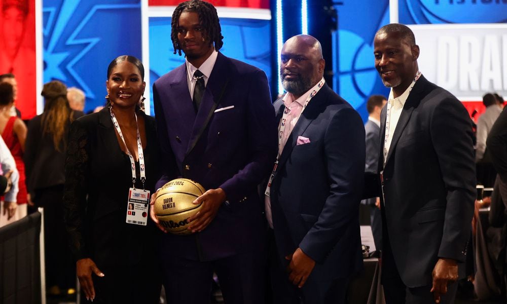 DaRon Holmes II poses for a photo with his mom Tomika, dad DaRon Sr. and Dayton's Anthony Grant before the NBA Draft on Wednesday, June 26, 2024, at the Barclays Center in Brooklyn, N.Y. David Jablonski/Staff