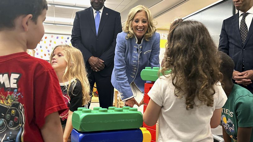 First lady Jill Biden, center, and Defense Secretary Lloyd Austin, left, watch four and five-year-olds build with blocks at a military early childhood education program at Maxwell Air Force Base in Alabama, Friday, Sept. 13, 2024. (AP Photo/Tara Copp)